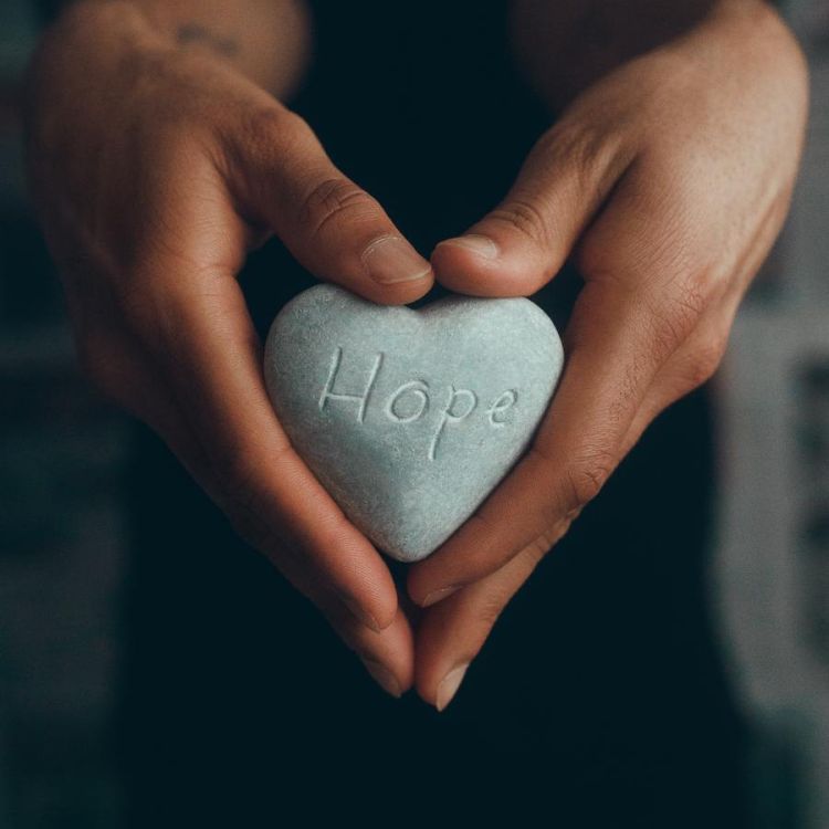 person holding a hope rock
